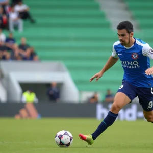 Football player with the ball in a match wearing Birmingham City colors