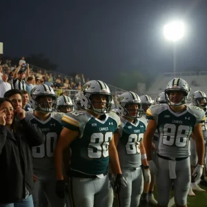 Exciting high school football action in Birmingham with players and cheering fans.