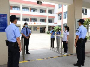 Security personnel at Bessemer City High School monitoring access
