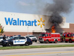 Police and fire vehicles outside the damaged Homewood Walmart Supercenter following an arson incident.