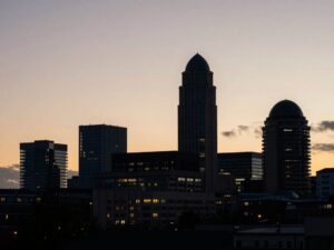 Silhouette of The City Club building against a colorful Birmingham skyline.